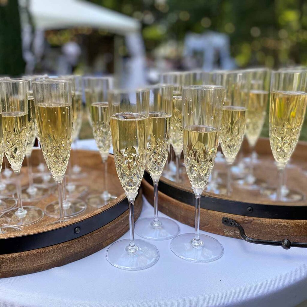 Full Champagne glasses on serving trays
